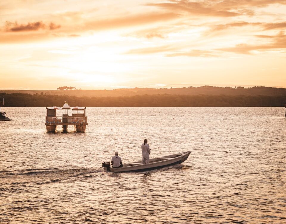 Como evitar doenças comuns ao visitar cidades brasileiras litorâneas Fishermen on Motorboat at Sunset