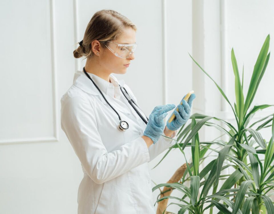Doctor Using her Smartphone near the Green Plants